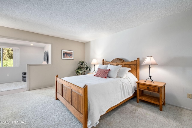 bedroom with light carpet and a textured ceiling