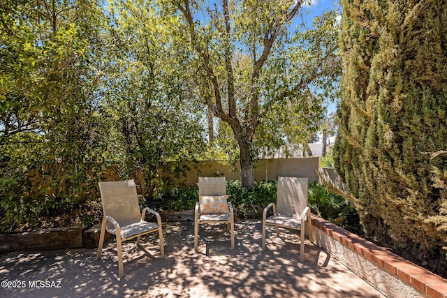view of patio featuring fence