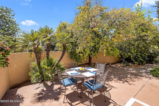 view of patio featuring a fenced backyard and outdoor dining area