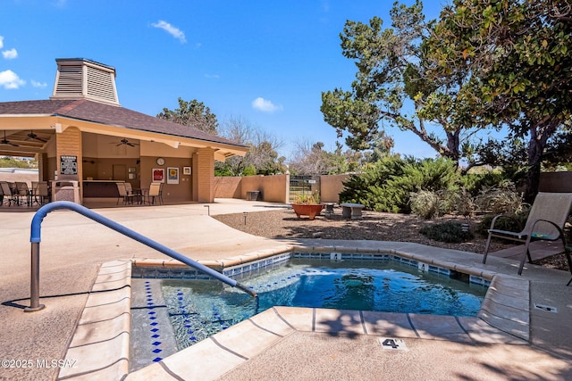 view of swimming pool with a patio area, ceiling fan, and fence