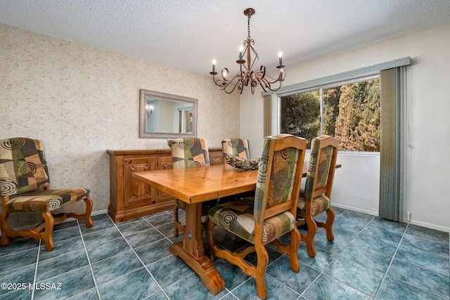 dining area featuring a chandelier, a textured ceiling, and baseboards