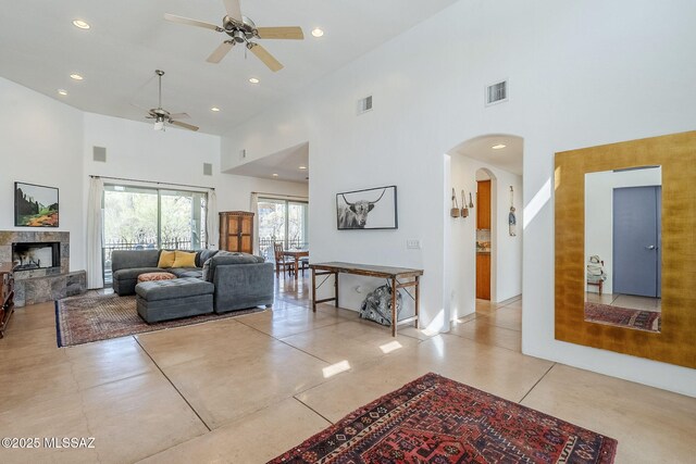 738 S Tohono Ridge Pl, Tucson, AZ 85745 - living area with a towering ceiling, a ceiling fan, arched walkways, a fireplace, and recessed lighting