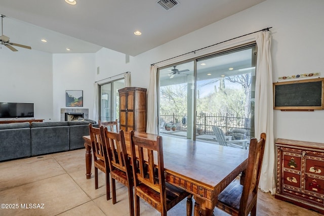 738 S Tohono Ridge Pl, Tucson, AZ 85745 - dining area with ceiling fan, a tiled fireplace, recessed lighting, and light tile patterned floors