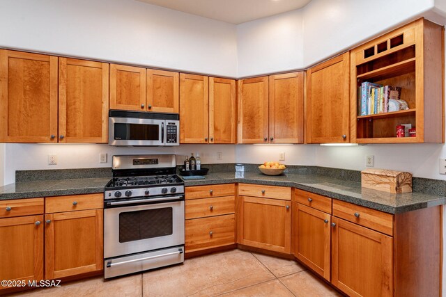 738 S Tohono Ridge Pl, Tucson, AZ 85745 - kitchen with appliances with stainless steel finishes, brown cabinetry, light tile patterned floors, and open shelves