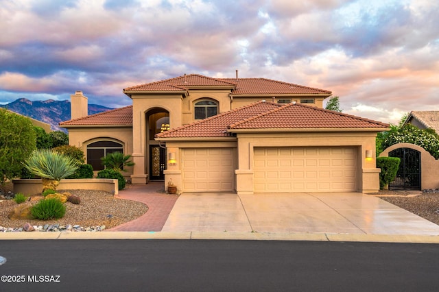 37717 S Terrace Park Dr, Saddlebrooke, AZ 85739 - mediterranean / spanish-style house with a garage, stucco siding, concrete driveway, a tile roof, and a chimney