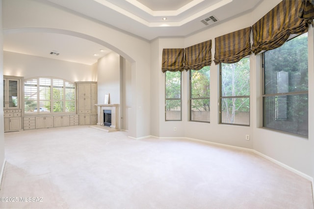 37717 S Terrace Park Dr, Saddlebrooke, AZ 85739 - unfurnished living room with arched walkways, light colored carpet, a fireplace with raised hearth, baseboards, and recessed lighting