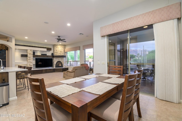 37717 S Terrace Park Dr, Saddlebrooke, AZ 85739 - dining area with ceiling fan, a fireplace, light tile patterned floors, and recessed lighting