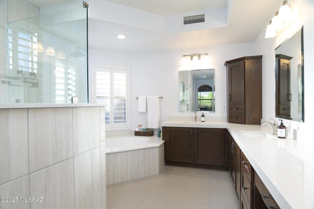 37717 S Terrace Park Dr, Saddlebrooke, AZ 85739 - full bathroom featuring tile patterned floors, a bath, two vanities, a walk in shower, and recessed lighting