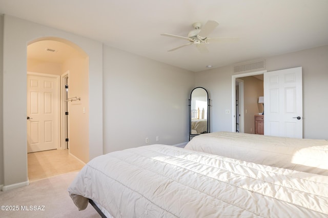 37717 S Terrace Park Dr, Saddlebrooke, AZ 85739 - bedroom with arched walkways, light colored carpet, baseboards, and a ceiling fan