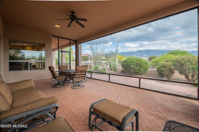 37717 S Terrace Park Dr, Saddlebrooke, AZ 85739 - sunroom / solarium with a ceiling fan, a mountain view, and brick floors