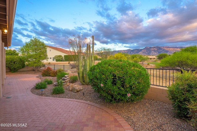37717 S Terrace Park Dr, Saddlebrooke, AZ 85739 - yard at dusk featuring a patio area, a mountain view, and a fenced backyard