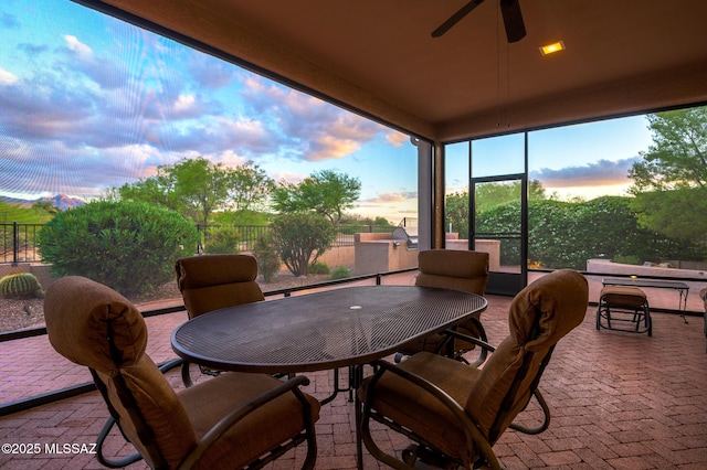 37717 S Terrace Park Dr, Saddlebrooke, AZ 85739 - sunroom featuring outdoor dining area, ceiling fan, and brick floors