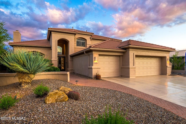 37717 S Terrace Park Dr, Saddlebrooke, AZ 85739 - mediterranean / spanish-style home with a garage, stucco siding, driveway, and a chimney