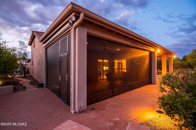 37717 S Terrace Park Dr, Saddlebrooke, AZ 85739 - view of home's exterior with a sunroom, stucco siding, a patio area, and a ceiling fan