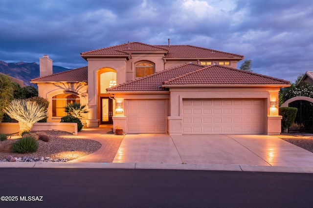 37717 S Terrace Park Dr, Saddlebrooke, AZ 85739 - mediterranean / spanish-style house featuring a garage, concrete driveway, stucco siding, a tiled roof, and a chimney