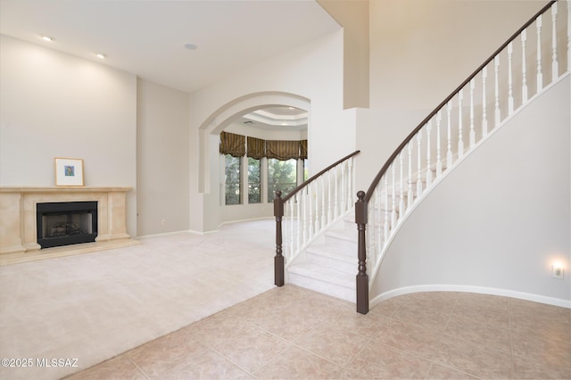 37717 S Terrace Park Dr, Saddlebrooke, AZ 85739 - stairs featuring carpet flooring, tile patterned floors, arched walkways, recessed lighting, and baseboards