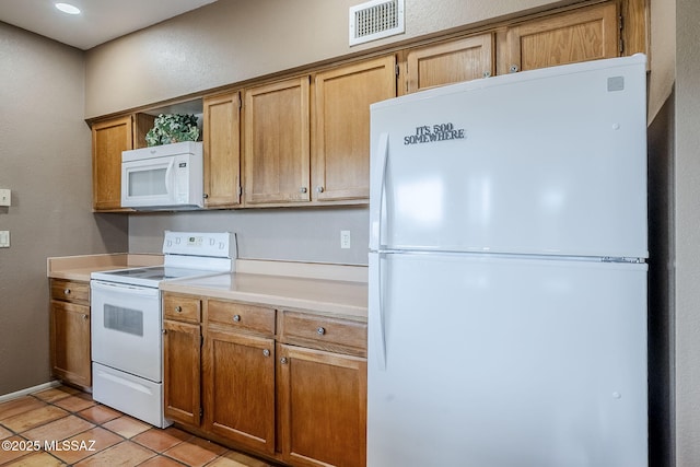 kitchen featuring a textured wall, white appliances, light tile patterned floors, light countertops, and visible vents