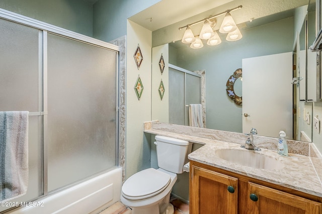 full bathroom featuring toilet, vanity, and bath / shower combo with glass door