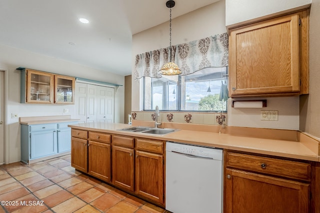 kitchen featuring glass insert cabinets, light countertops, dishwasher, a sink, and hanging light fixtures