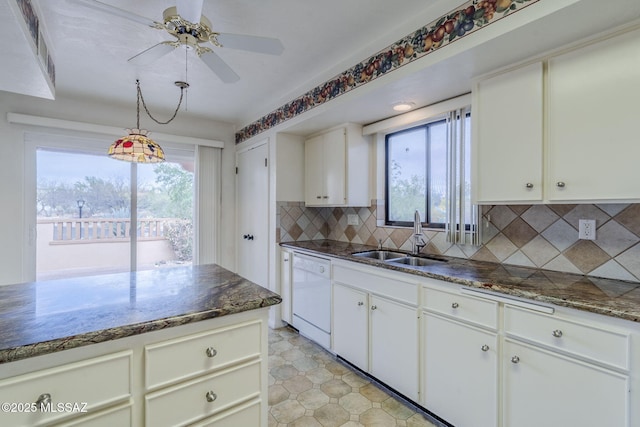 kitchen featuring a wealth of natural light, a sink, backsplash, and white dishwasher