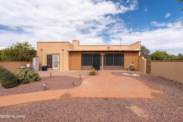 back of property with a patio, fence, and stucco siding