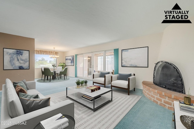 living area featuring an inviting chandelier and carpet flooring