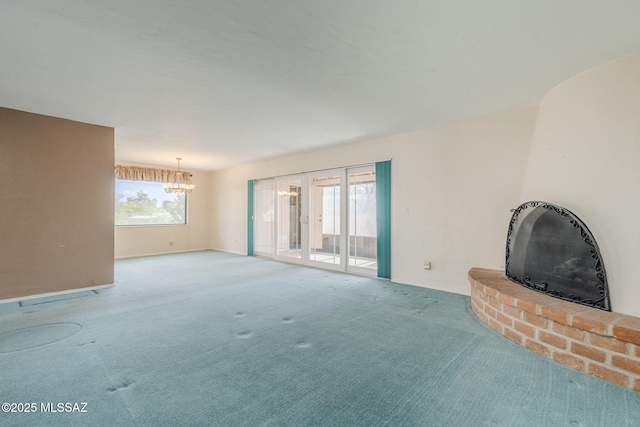 unfurnished living room with a chandelier and carpet flooring