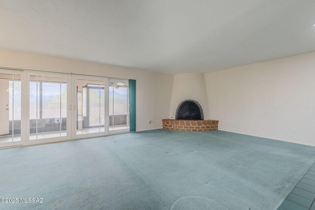 unfurnished living room with a fireplace and carpet