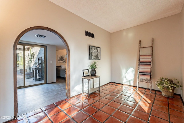 4401 E Havasu Rd, Tucson, AZ 85718 - unfurnished room with visible vents, tile patterned floors, and arched walkways