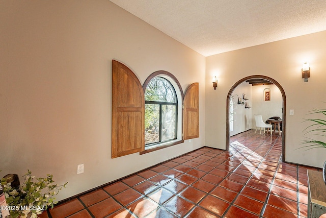 4401 E Havasu Rd, Tucson, AZ 85718 - tiled entryway with arched walkways, lofted ceiling, and a textured ceiling