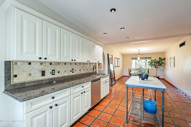 4401 E Havasu Rd, Tucson, AZ 85718 - kitchen featuring light tile patterned floors, a sink, white cabinetry, backsplash, and stainless steel dishwasher