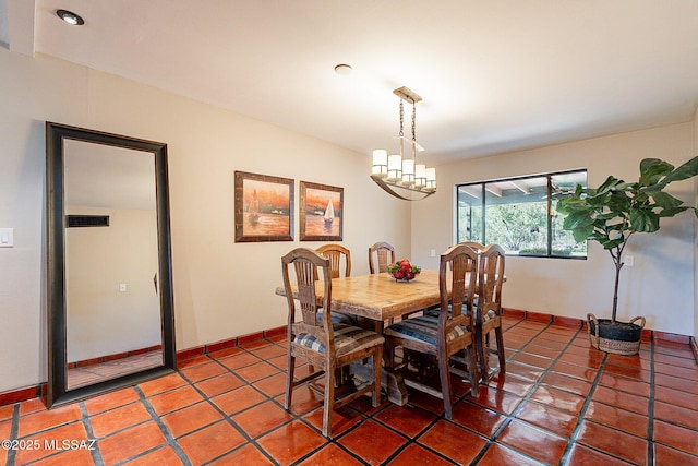 4401 E Havasu Rd, Tucson, AZ 85718 - dining space with a chandelier, light tile patterned floors, and baseboards