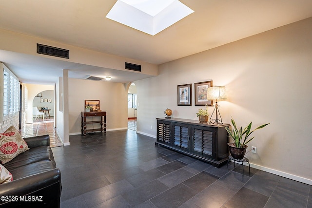 4401 E Havasu Rd, Tucson, AZ 85718 - interior space featuring visible vents, baseboards, arched walkways, and a skylight