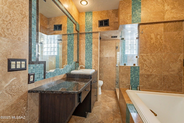 4401 E Havasu Rd, Tucson, AZ 85718 - bathroom with a bath, visible vents, toilet, tile walls, and a stall shower