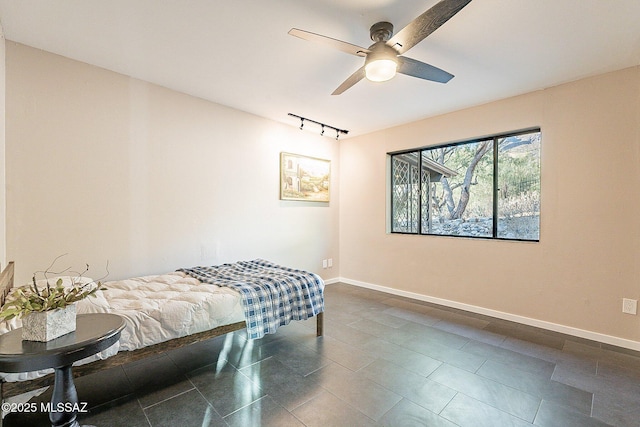 4401 E Havasu Rd, Tucson, AZ 85718 - bedroom with track lighting, ceiling fan, baseboards, and dark tile patterned floors