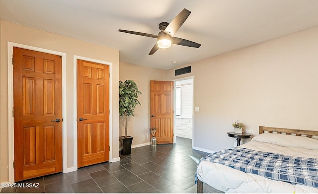 4401 E Havasu Rd, Tucson, AZ 85718 - bedroom featuring dark tile patterned floors, visible vents, baseboards, and ceiling fan