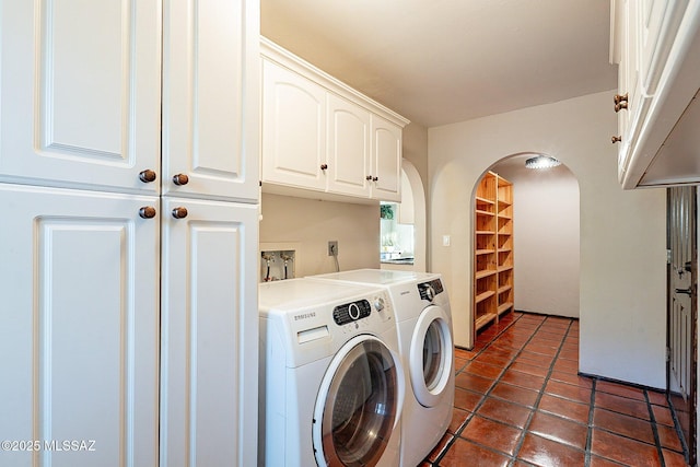 4401 E Havasu Rd, Tucson, AZ 85718 - laundry area with cabinet space, washing machine and clothes dryer, dark tile patterned floors, and arched walkways