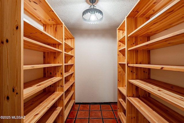 4401 E Havasu Rd, Tucson, AZ 85718 - laundry room featuring arched walkways, dark tile patterned floors, cabinet space, and washer and clothes dryer