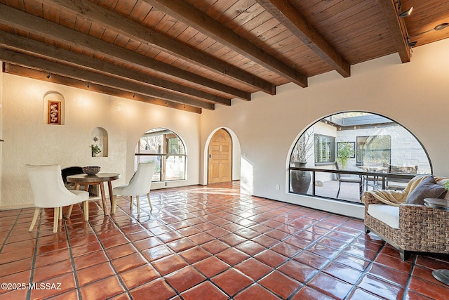 4401 E Havasu Rd, Tucson, AZ 85718 - tiled living area with beamed ceiling, wooden ceiling, arched walkways, and a textured wall