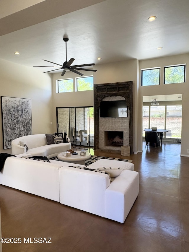 living room featuring a ceiling fan, recessed lighting, and a healthy amount of sunlight