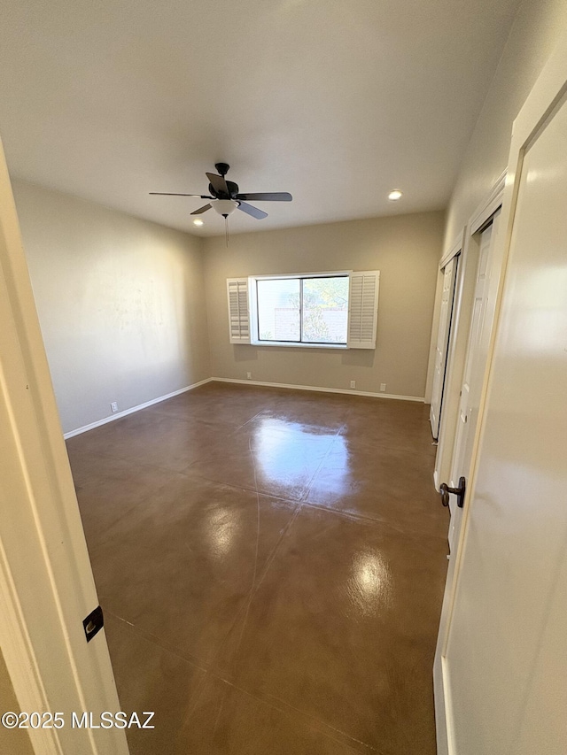 unfurnished bedroom with ceiling fan, baseboards, finished concrete floors, and recessed lighting