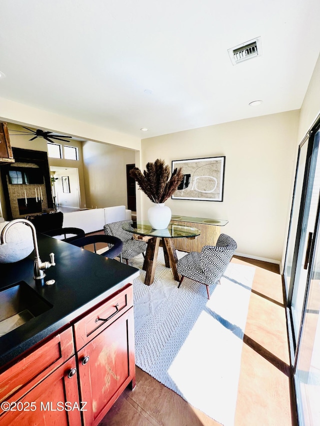 interior space featuring visible vents, ceiling fan, and a healthy amount of sunlight