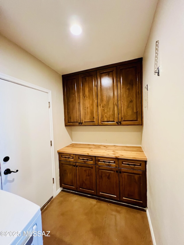 clothes washing area with baseboards, recessed lighting, light colored carpet, and cabinet space