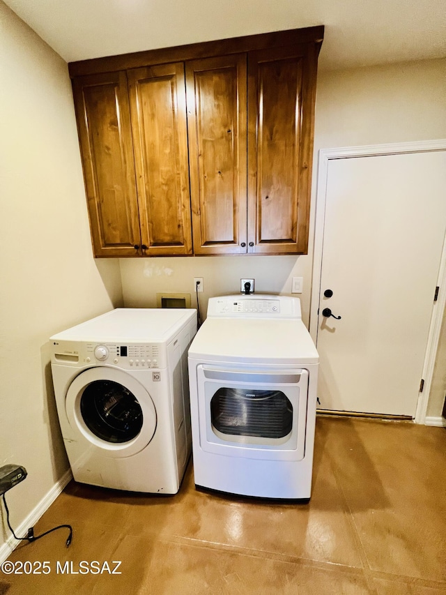 washroom featuring separate washer and dryer, baseboards, and cabinet space