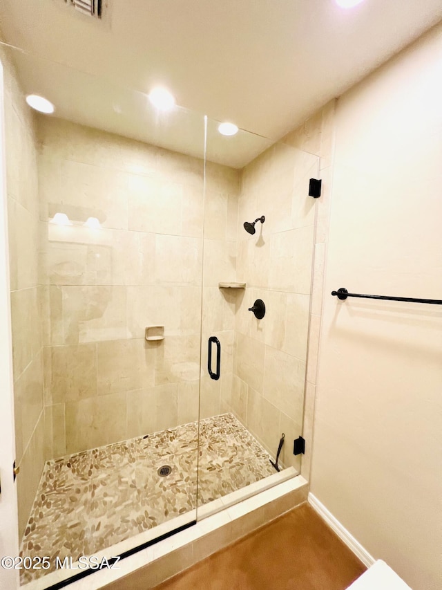 bathroom with recessed lighting, baseboards, and a stall shower