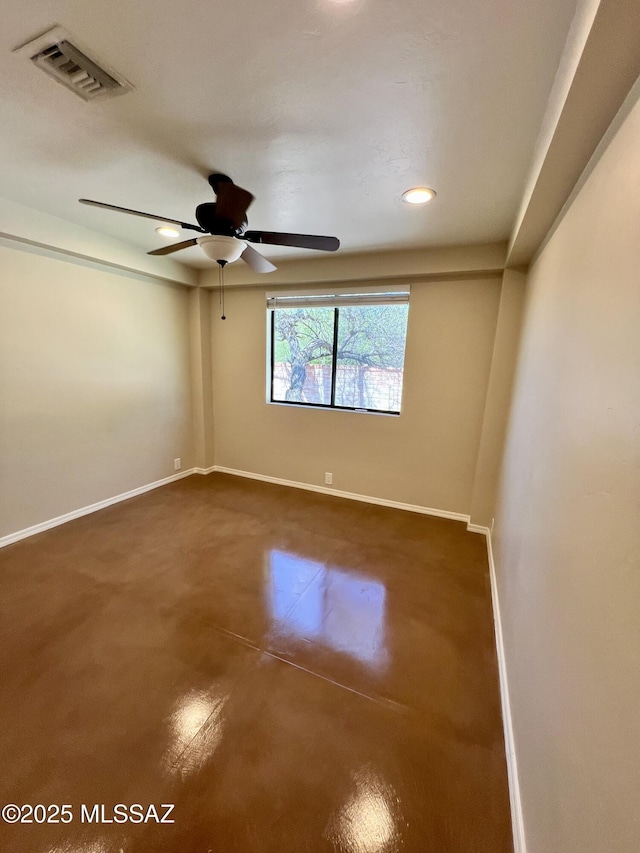 spare room with recessed lighting, visible vents, finished concrete flooring, and baseboards