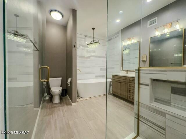 bathroom with recessed lighting, an enclosed shower, visible vents, vanity, and a freestanding tub