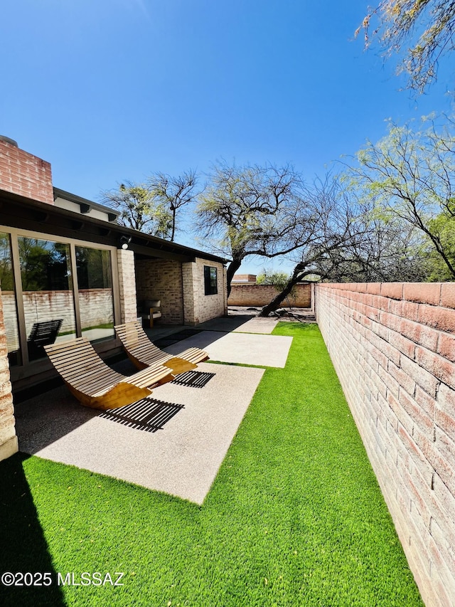 view of yard with a fenced backyard and a patio