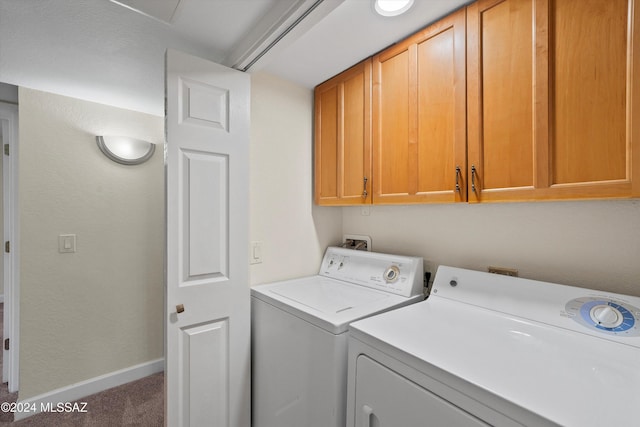 laundry area featuring washer and dryer, carpet, baseboards, and cabinet space