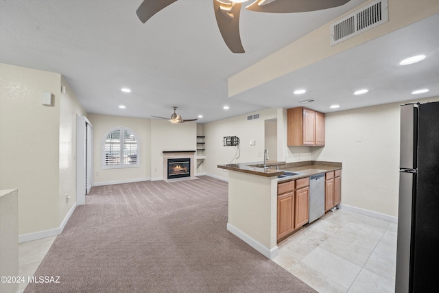 kitchen featuring freestanding refrigerator, a ceiling fan, visible vents, and stainless steel dishwasher